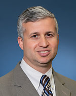 Andres Schanzer, MD, FACS headshot in a suit and tie