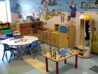 Cabinets filled with toys align the muraled wall at Shelly's Place.