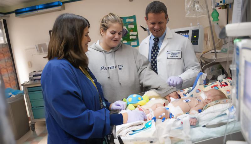 A mother visits her baby in the PICU and talks to medical staff.