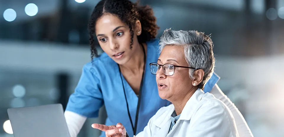 Two providers reviewing a computer document