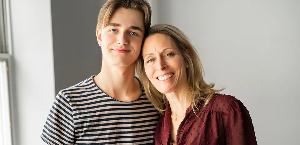 teen boy and mom at college dorm room