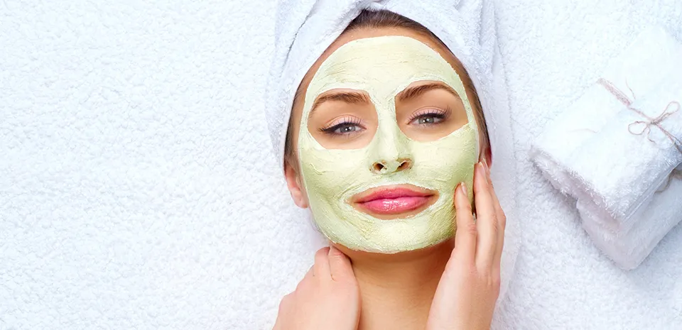 woman at the spa having a facial skin mask