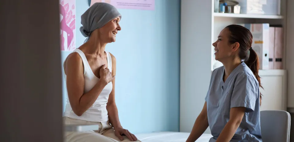 woman cancer patient talking to radiation therapy provider