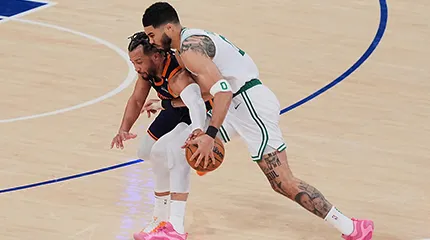 New York Knicks' Jalen Brunson, left, defends Boston Celtics' Jayson Tatum, right, during the first half of Game 4 in the Eastern Conference semifinals of the NBA basketball playoffs.