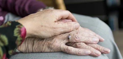 elderly hands on top of one another
