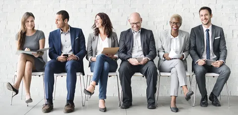 diverse group sitting in chairs and laughing