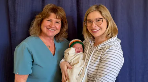 Grandmother Mary Jo Peters, 59, stands with mother Caitlyn O'Brien, 32, as she holds Shawn O'Brien, was born on March 16, 2026 at 3:16 pm.