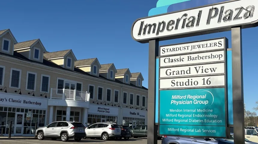 The Imperial Plaza in Mendon, Mass. The exterior of the while building has several cars in front. A sign reads "Milford Regional Physician Group."
