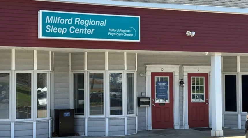 The exterior of Milford Regional Sleep Center in Milford, Mass. The white building has a red facade.