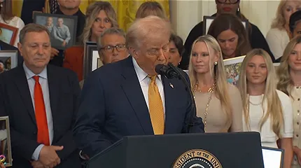 President Trump speaks at a podium.