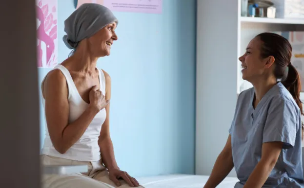 woman cancer patient talking to radiation therapy provider