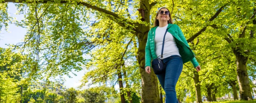 woman in jeans walking mindfully in a spring woods